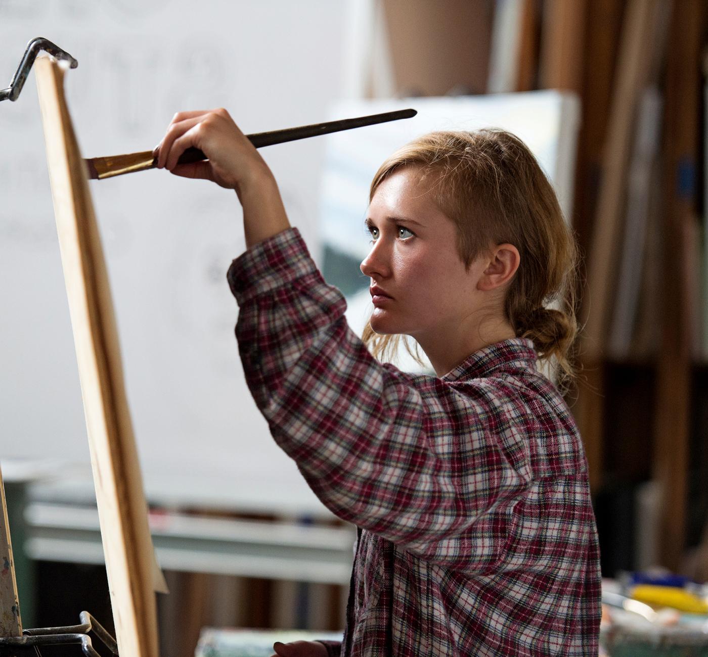 Woman painting at easel